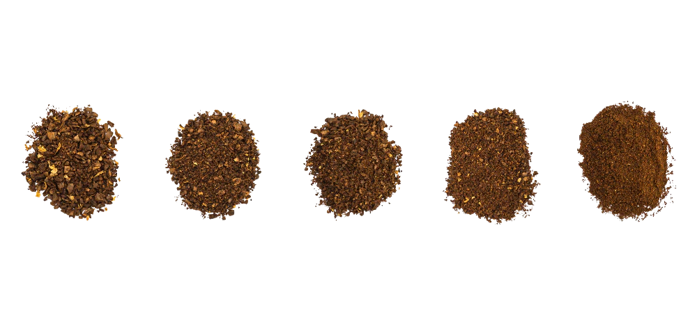Five small piles of ground coffee in a row, going from coarse on the left to fine on the right.